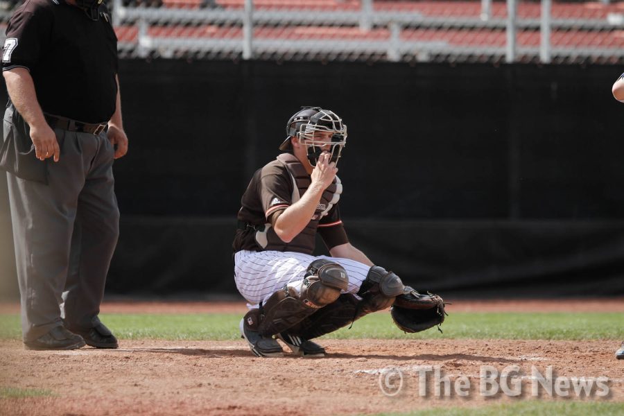 T.J. Losby, BG catcher, adjusts his mask before the next batter steps up and the next pitch is thrown.