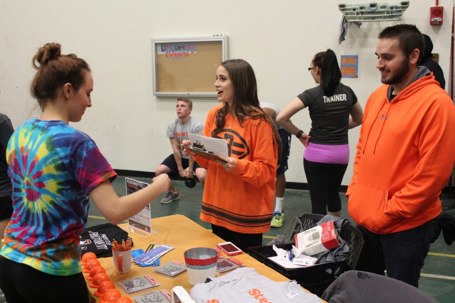 Students look through table with souvenirs at the Exercise Science Fair on Friday.