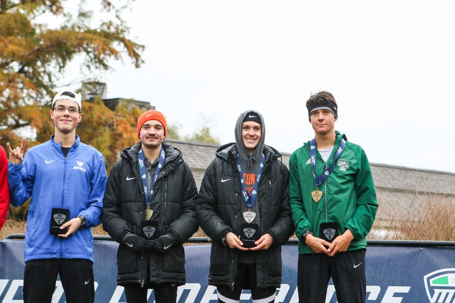 Tyler Phillips and Noah Schaub (middle) receive their medals for placing third and second place in the MAC Championships.