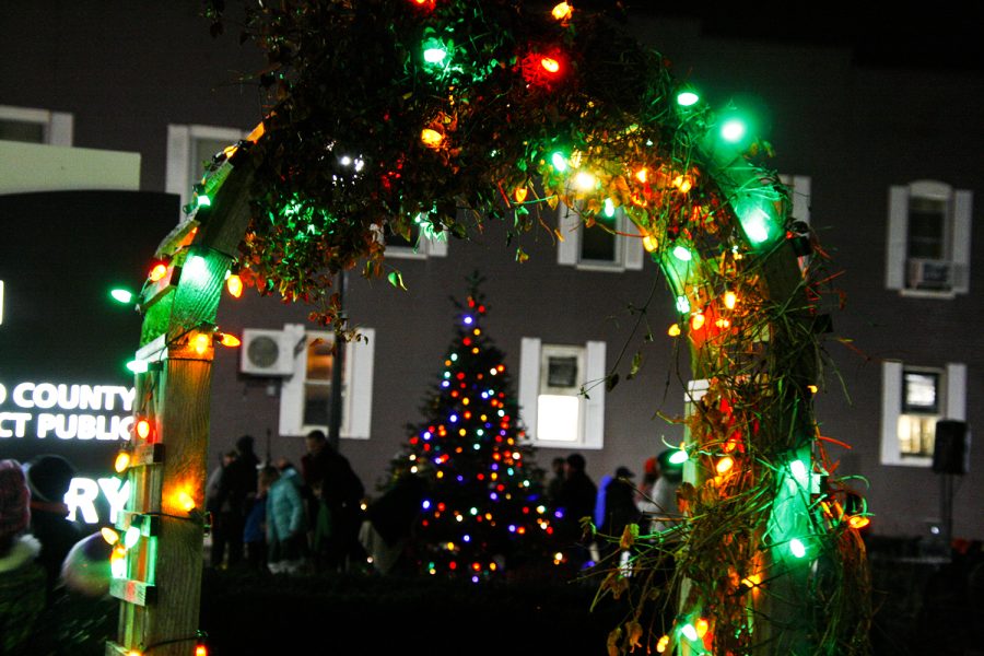 Community members gather by the Wood County Public Library for a tree lighting ceremony.