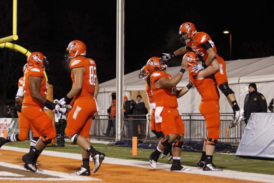 BG+Football+celebrates+together+after+a+touchdown+in+their+49-0+win+over+Ohio+University+Tuesday+night+at+the+Doyt.