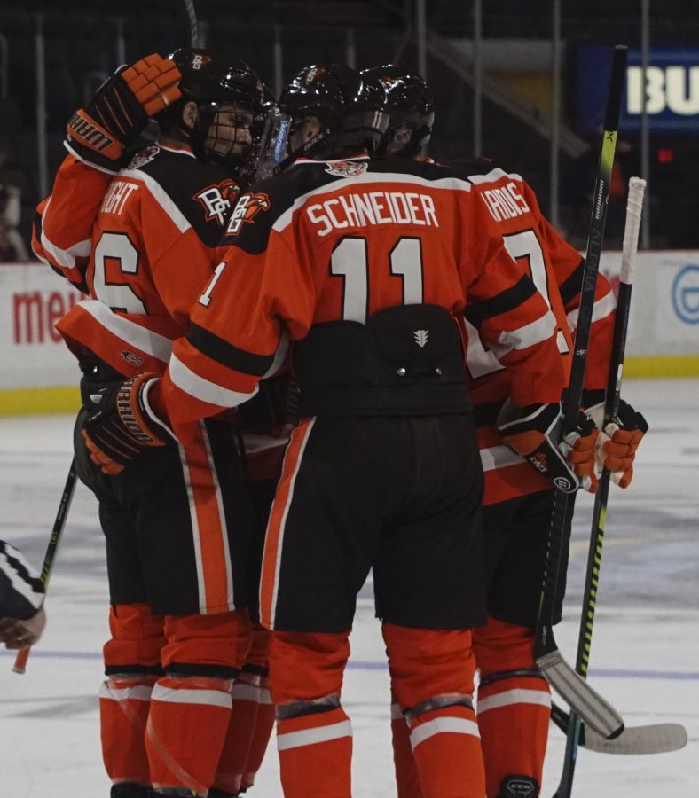 Cameron+Wright%2C+Taylor+Schneider+and+Tim+Theocharidis+celebrate+a+goal+against+R.I.T.