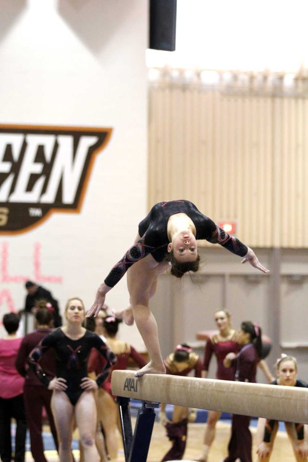 BG Gymnast does her flip on the balance beam in their home meet against Central Michigan on Feb.,  9. They are currently ranked in the top 36 in the country.