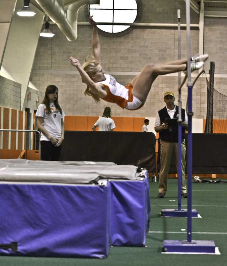 Emily Gerken jumps in the high jump competition in a home indoor meet earlier this season.