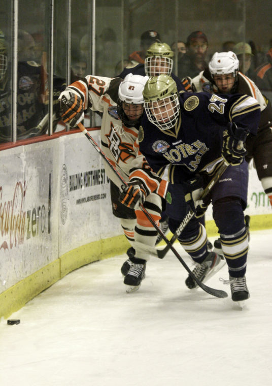 Andrew Wallace fights off a Notre Dame defender to gain an advantage to get to the puck.