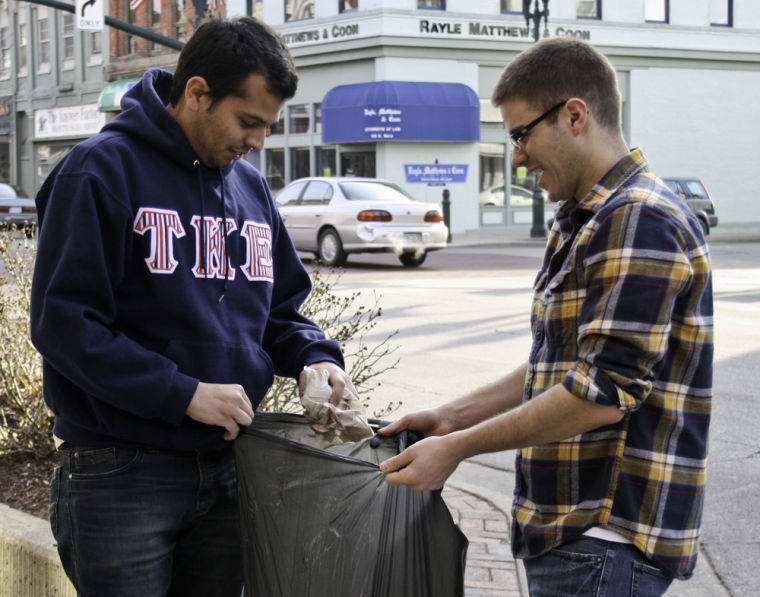 Picking+up+trash+on+the+side+of+Main+Street+is+junior+and+TKE+President+Pedro+Petribu+and+sophomore+and+TKE+Community+Service+Chair+Pat+Gallagher.+The+two+students+are+volunteering+to+help+pick+up+trash+after+the+weekend%26%238217%3Bs+St.+Patrick%26%238217%3Bs+Day+celebration+downtown.