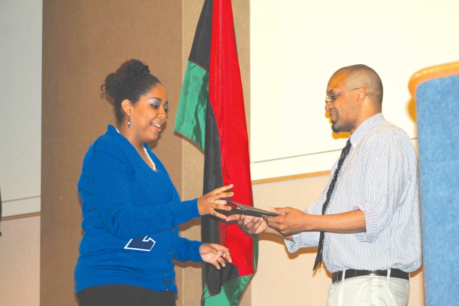 ASHLEY EDWARDS receives an award during the Black Student Union and National Pan-Hellenic Council commencement ceremony Sunday night in the Union ballroom.