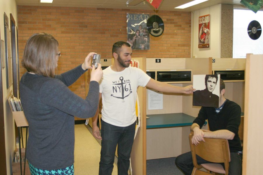 Senior Aby Morales, a student worker at the music library, holds a record sleeve in front of 2nd year master’s student David Carson’s face as Student Supervisor Liz Tousey takes a photo. The students are sleevefacing.