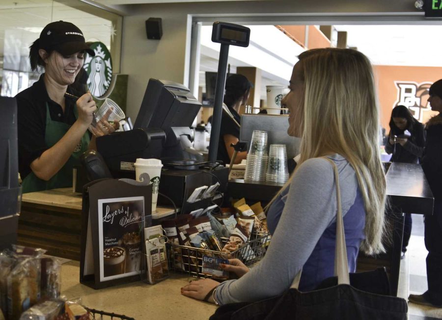 Trisha Conley (right), sophomore, orders an iced coffee at Starbucks Monday morning to start her day. She spends an average of $21.25 on coffee each week.