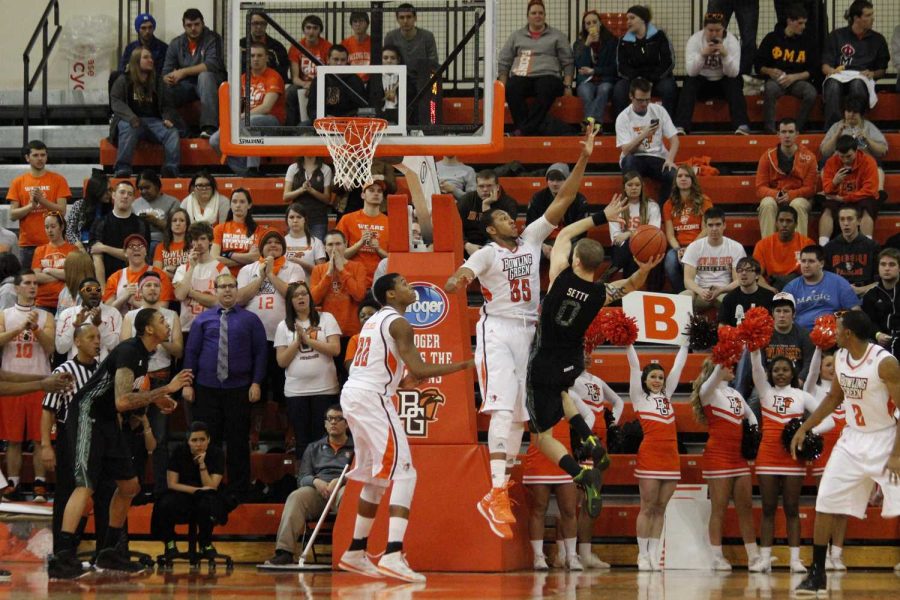 Cameron Black guards the basket against a defender with the help of teammate Richaun Holmes in a game earlier this season at the Stroh Center.