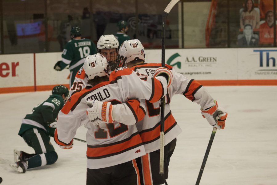 BGSU hockey players Gavin Gould (12), Evan Dougherty (15) and Connor Ford (20) celebrate the goal that put the Falcons up 2-1 in their eventual 3-2 victory against Bemidji State on Thursday, Jan. 7, 2021 at Slater Family Ice Arena.