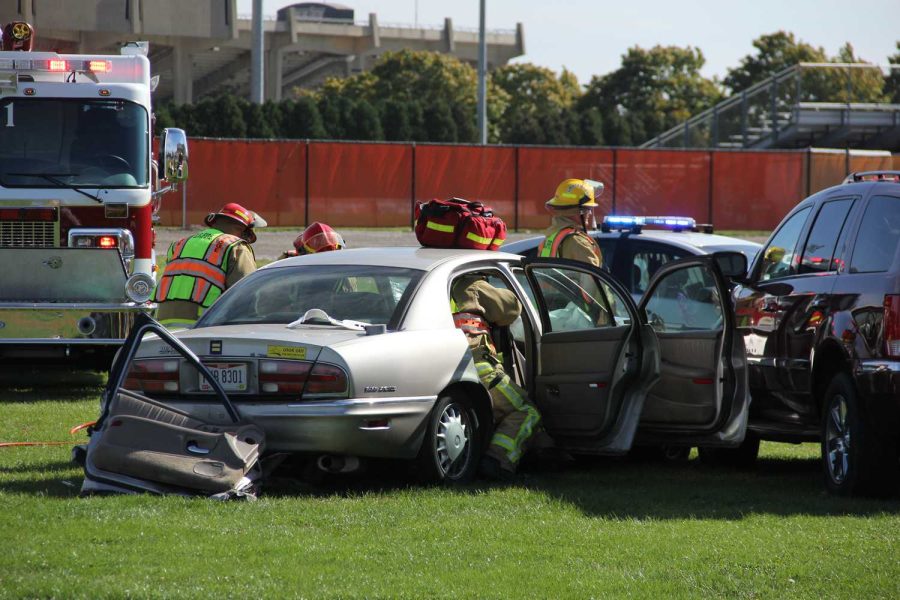 Firefighters work to carefully get a body out of the car during a mock car crash demonstration to show students what could happen driving under the influence on Tuesday afternoon.