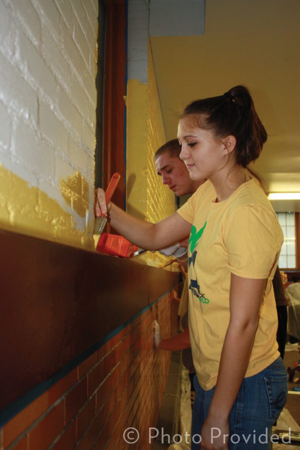 Freshman Ashley Corron applies yellow paint to the entrance
foyer of Family House, Toledo's largest homeless shelter. More than
200 freshmen painted the shelter this past Wednesday as a project
through Chapman Learning Community at Kohl Hall.