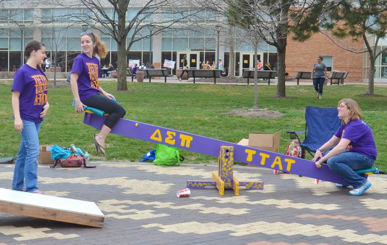 Chelsea Folk (left) a Junior majoring in Supply Chain Management is lifted up on the teeter totter by her fellow Delta Sigma Phi member Sarah Bartley a first semester senior in business management.