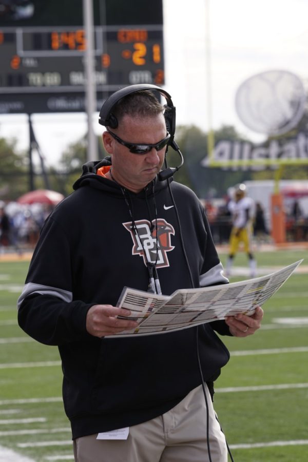 Football head coach Scot Loeffler goes over his notes from the sidelines during Saturdays loss against Central Michigan.