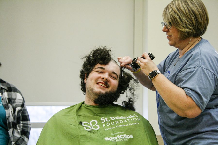 One of 103 participants in the shave-a-thon has his locks cut by a volunteer in the Bowen Thompson Student Union multipurpose room. 