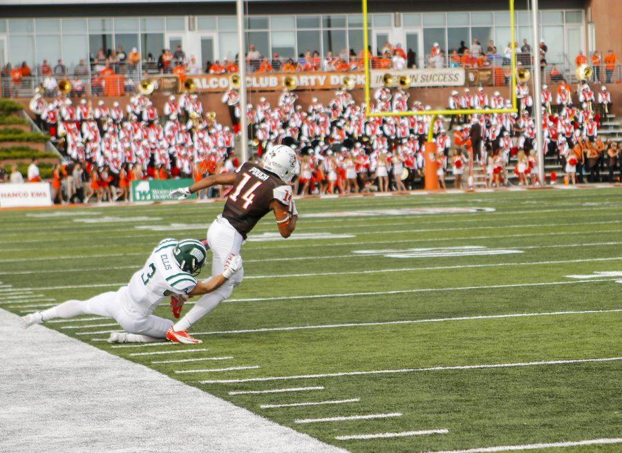 Falcons running back Andrew Clair gets taken down by an Ohio Bobcat defender.