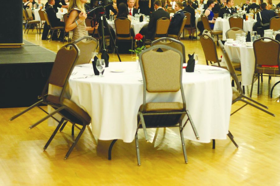 The prisoner of war table is set with five chairs to represent the five branches of the military and those who gave their lives or are missing in action.