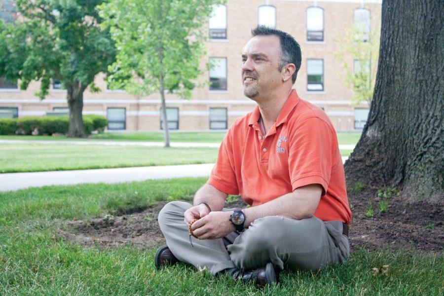 Professor meditating on campus