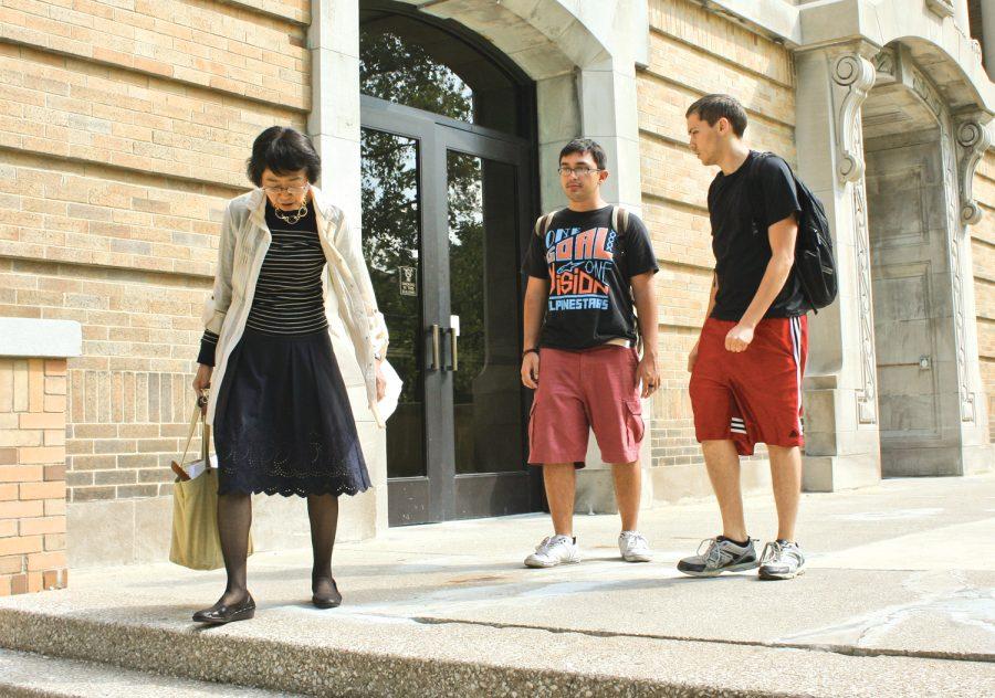 Juniors Dennis Cabrera (left) and Steven Sims leave University
Hall with their Japanese professor after class.
