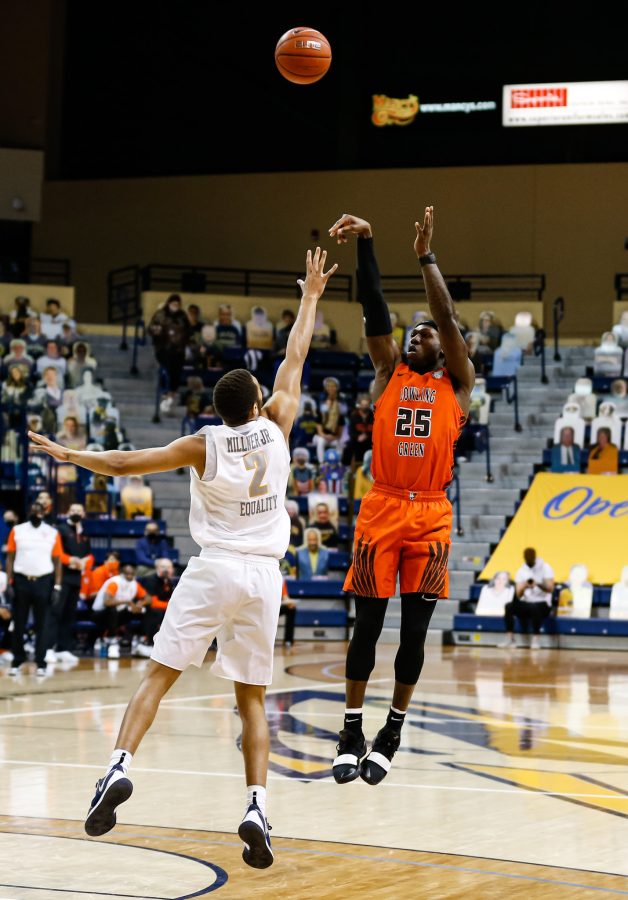 BGSUs Daeqwon Plowden shoots over Toledos Sentric Millner Jr. in the Falcons 88-81 win over the Rockets at Savage Arena on Saturday, Feb. 13, 2021.
