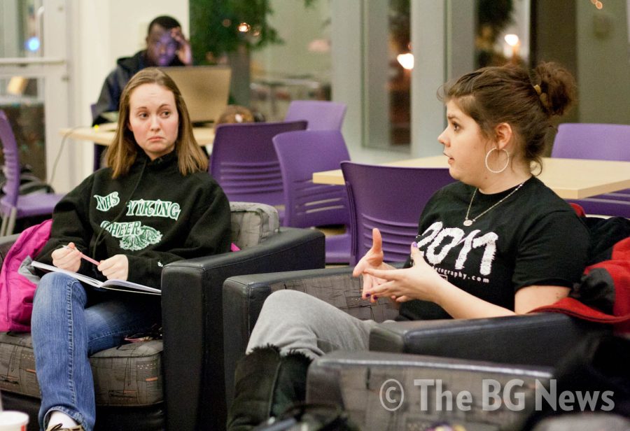 Krysten Abel (right), a sophmore, discusses her beliefs on
science and religion while Emily Freese, sophomore, listens during
a SEARCH meeting in the Union.