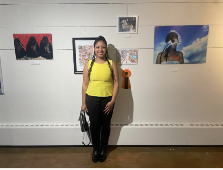BGSU Senior Genesis Salone next to “Be the Change,” winning her Best in Show for the 2D category.