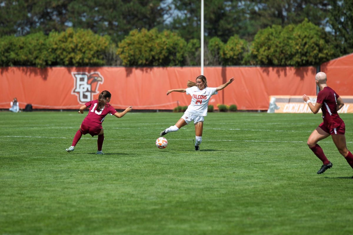 Emme Butera about to kick the ball up the pitch. 