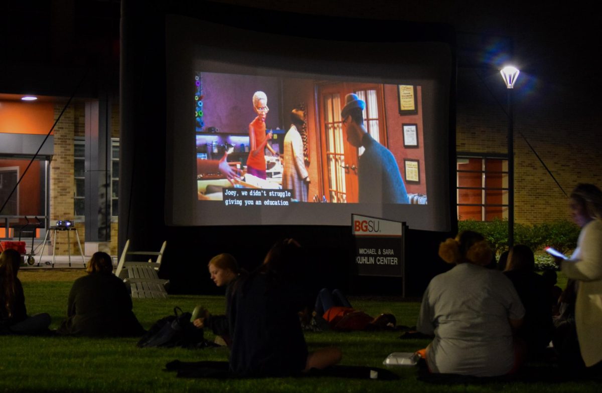 Members of the BGSU community enjoy a movie night in front of the Kuhlin Center during BGSU's Homecoming weekend.