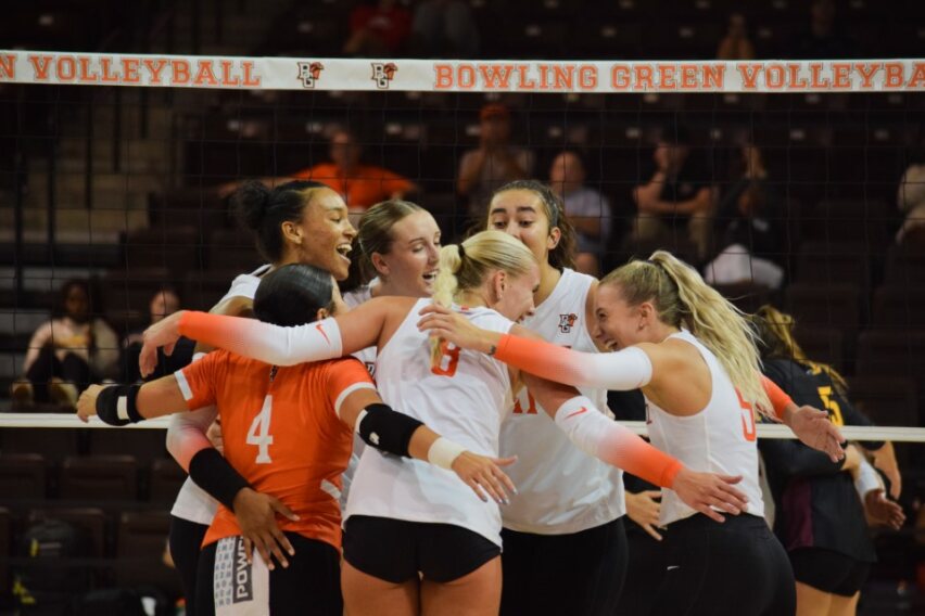 Team celebrates after scoring a point against Loyola-Chicago