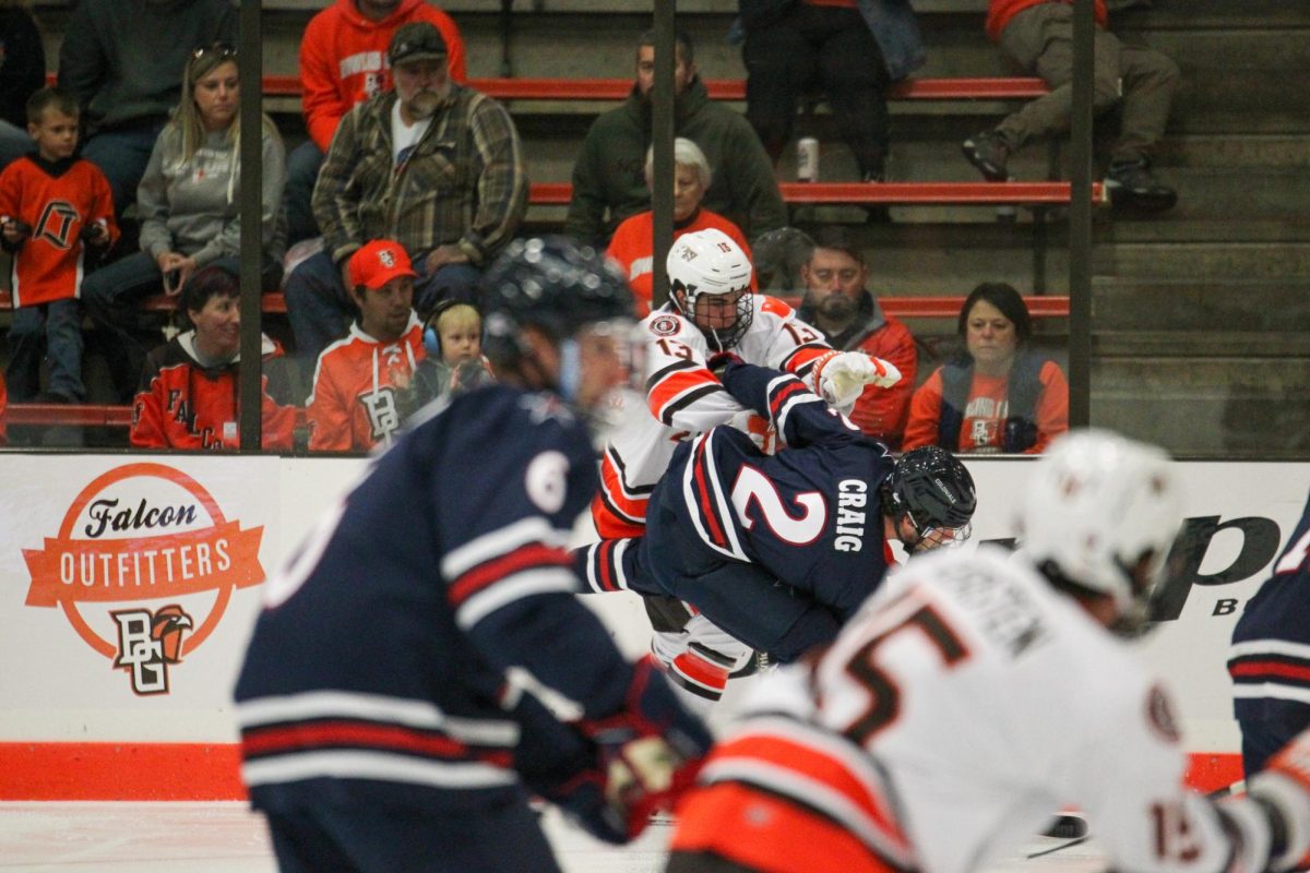 Brett Pfoh (13) laying a hit on a Robert Morris defender