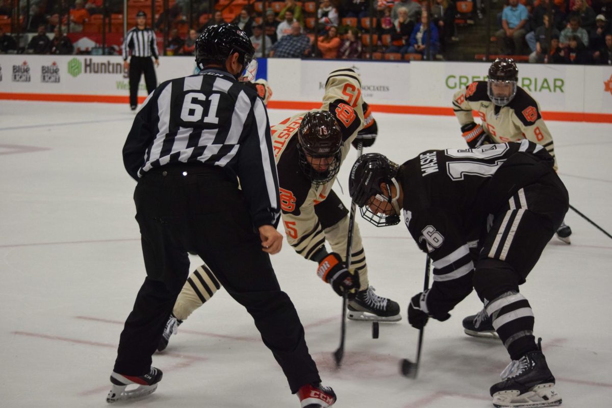Spencer Kersten fighting for the puck during the face-off.