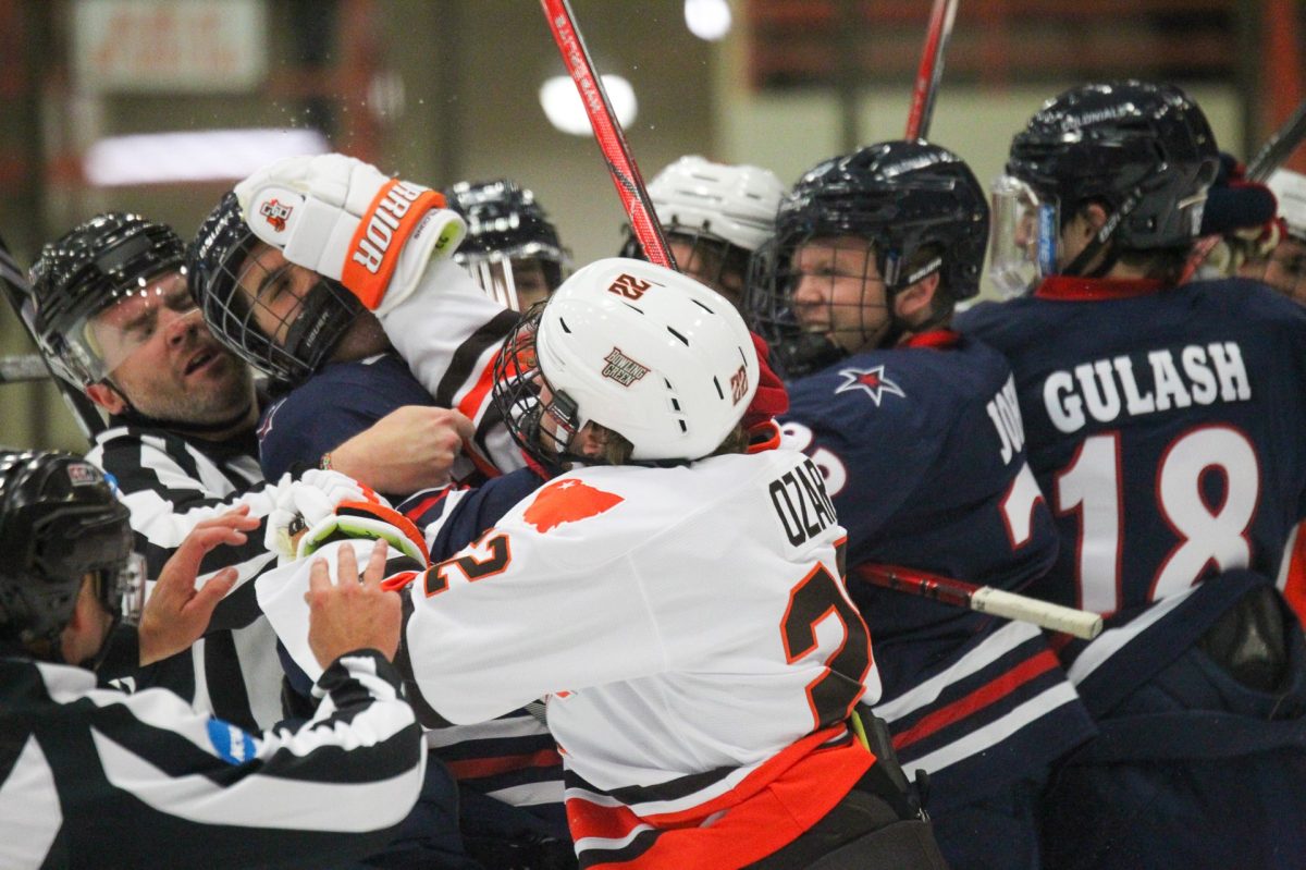BGs Owen Ozar gets into a fight with Robert Morris players in the first period