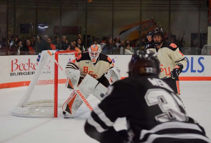 Goaltender Cole Moore protecting the net against Western Michigan