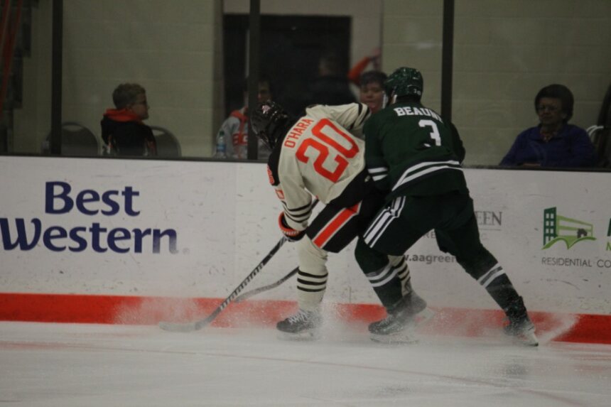 Ryan OHara battling against the boards with the puck