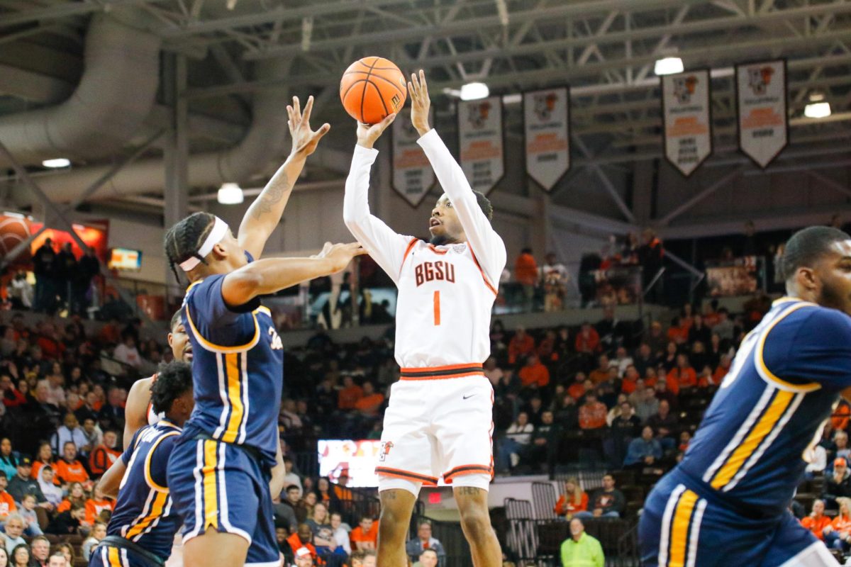 Trey Thomas (1) throwing up a jumper