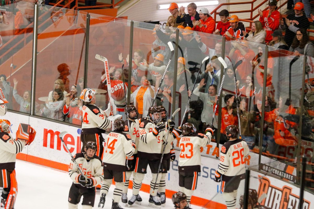 BGSU team celebrates with students after a sweep over the Lakers with a score of 4-2