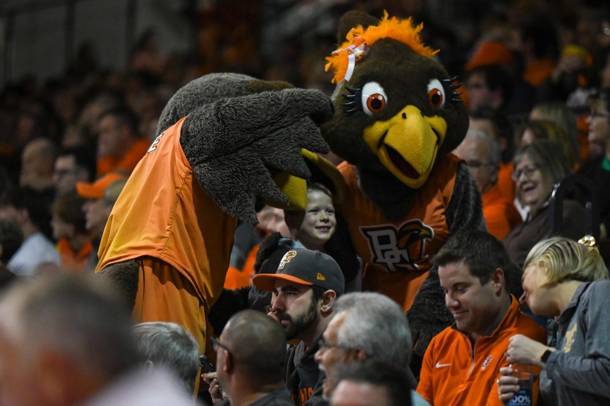 Freddie and Frieda Falcon taking pictures with fans.