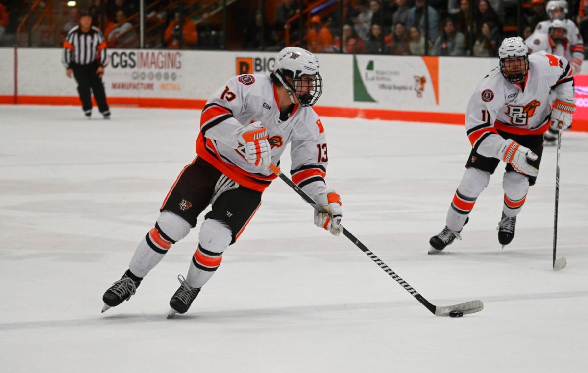 Brett Pfoh (13) carrying the puck into the zone