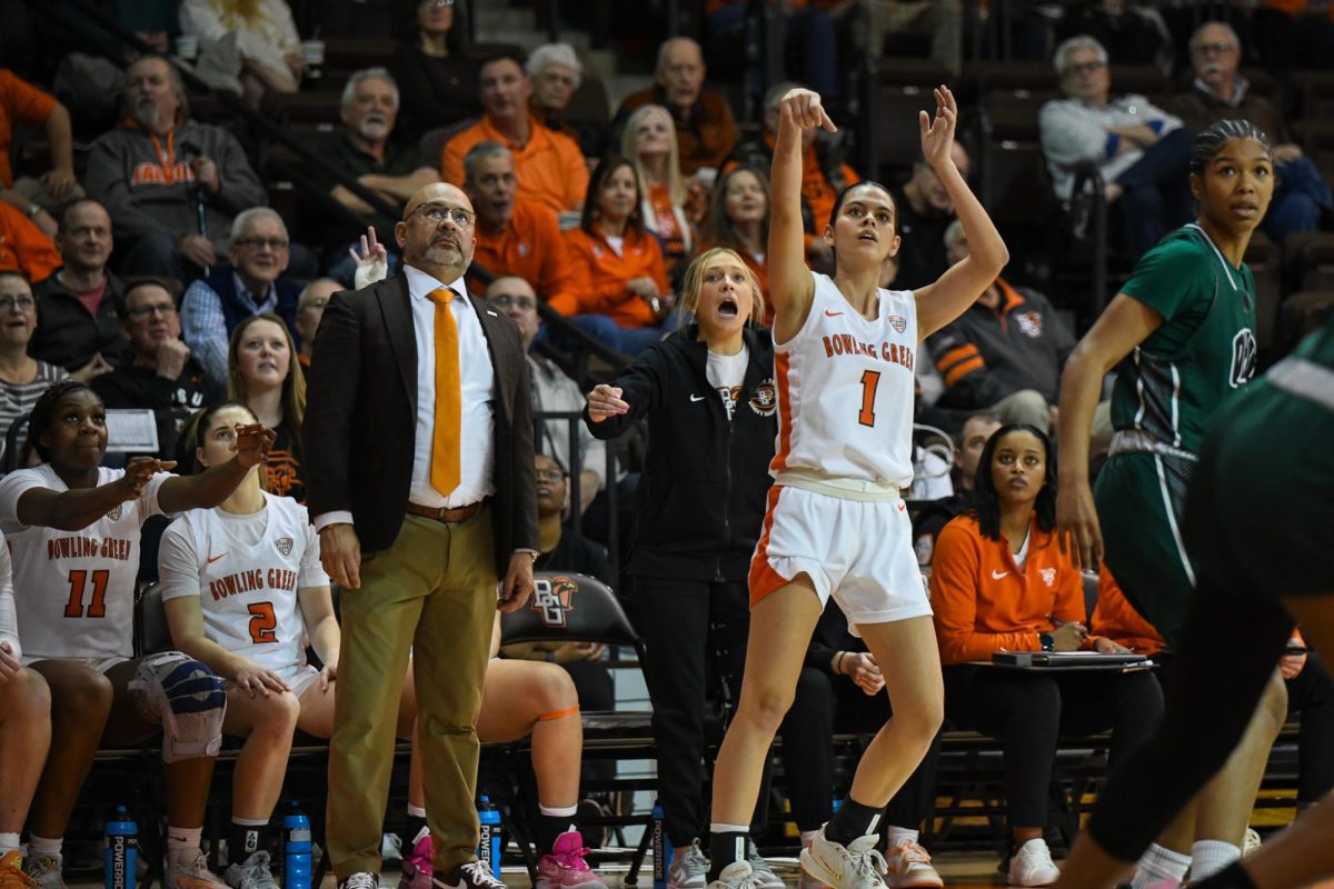 Amy Velasco (1) shooting a 3 right in front of the Falcon bench