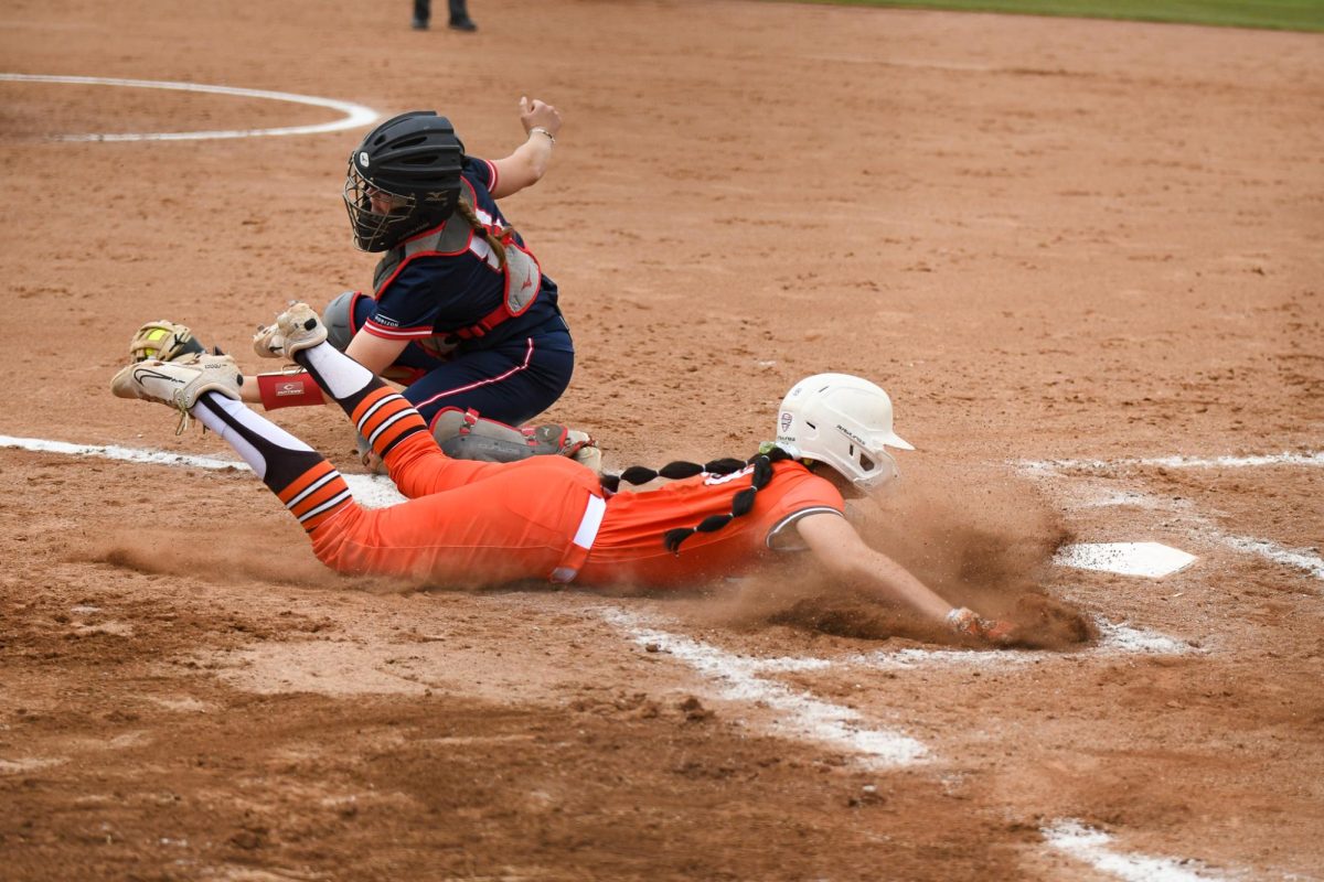 Bowling Green, OH - Game 1 Falcons freshman outfielder Kaylee Cole (99) sliding into home on a close play to score a run at Meserve Field in Bowling Green, Ohio