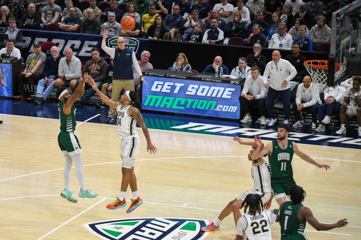 Cleveland, OH - Bobcats graduate Shareef Mitchell (4) shooting a 3 pointer over a Zips defender while the shot clock expires at Rocket Mortgage FieldHouse