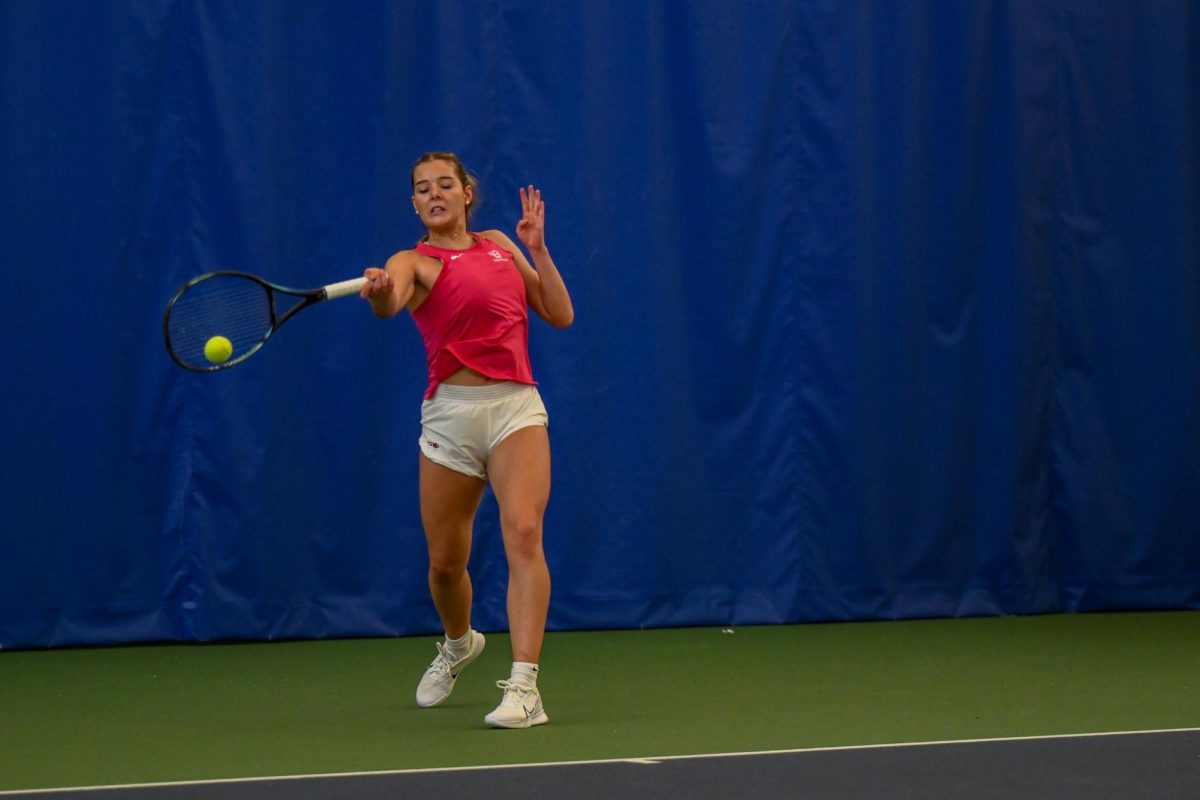 Perrysburg, OH - Falcons Isabella Baker returning a serve from the Cardinals at Perrysburg Tennis Center in Perrysburg, Ohio.