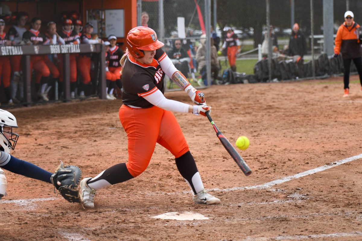 Bowling Green, OH - Falcons senior designated player Reagan Williamson (4) driving the ball to the outfield at Meserve Field in Bowling Green, Ohio