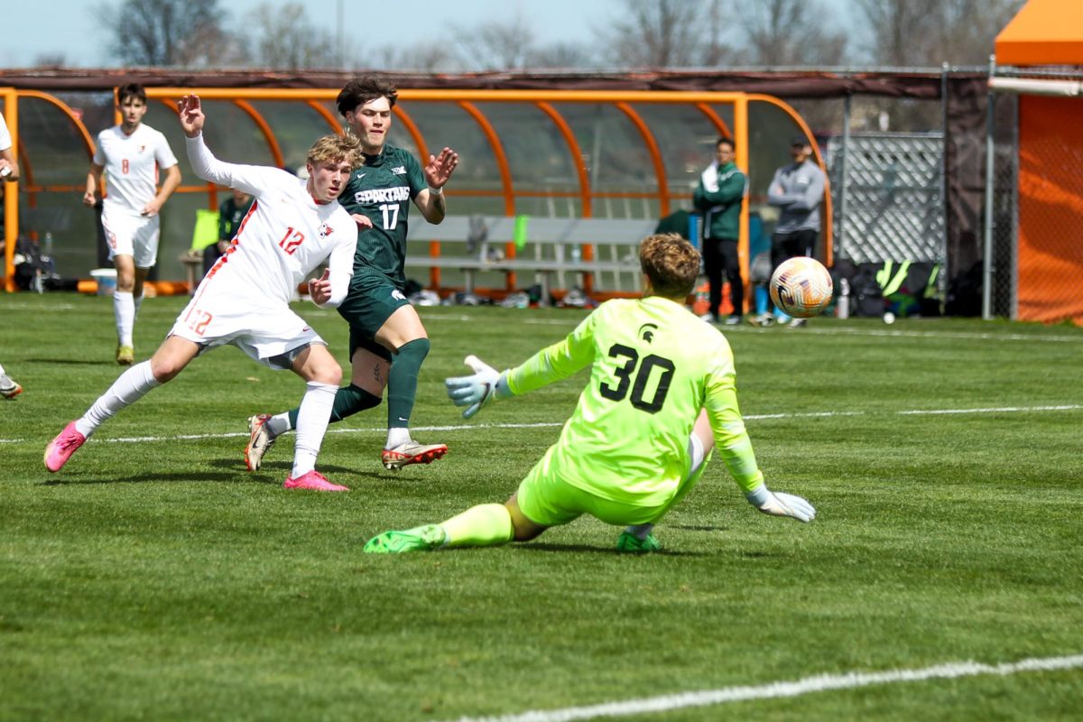 Bowling Green, OH - Falcons Forward Sophomore Bennett Painter (12) getting the ball away from Michigan State goalie  at Cochrane Soccer Field in Bowling Green, Ohio