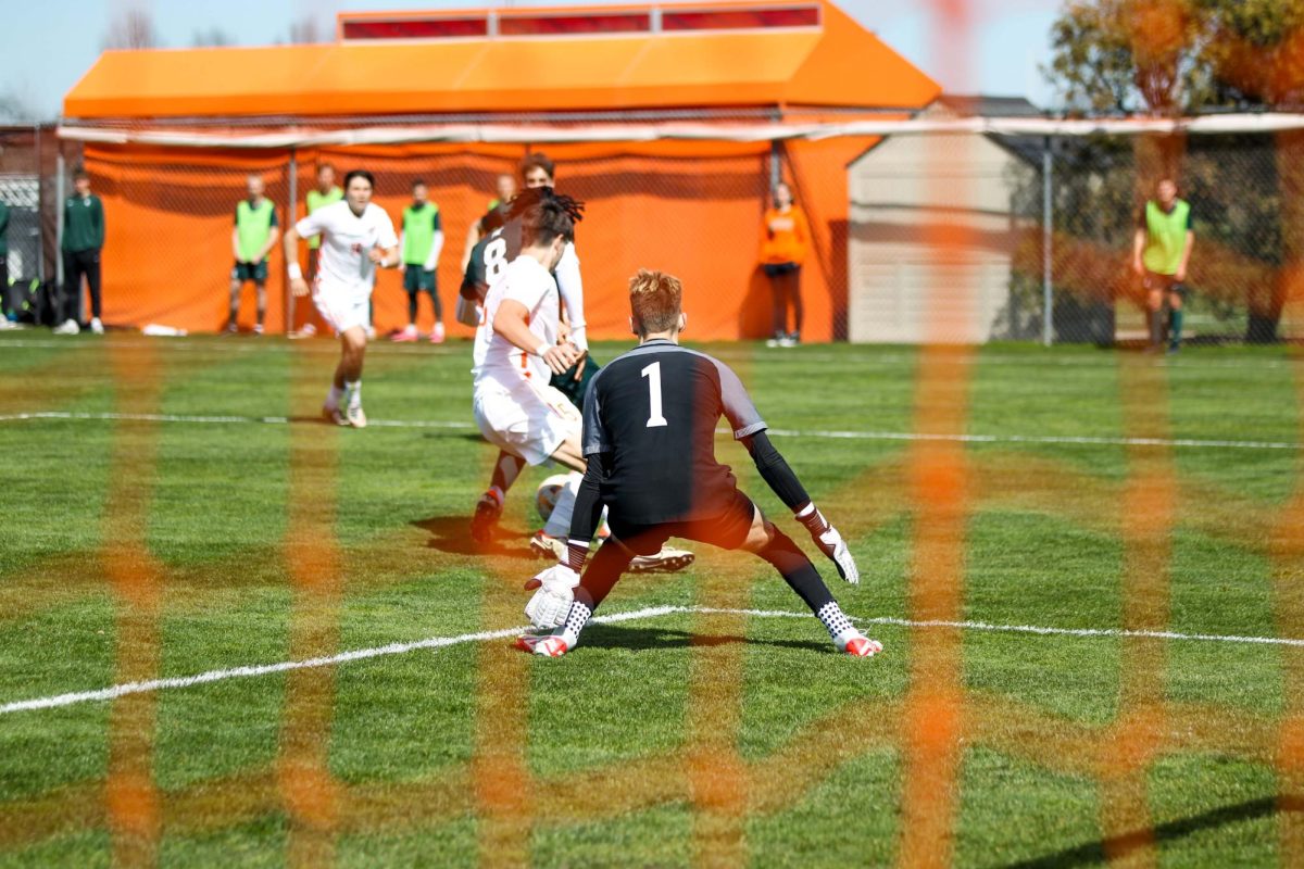 Bowling Green, OH - Falcons Goalie 5th year Grant Balcer(1) going to catch the ball at Cochrane Soccer Field in Bowling Green, Ohio