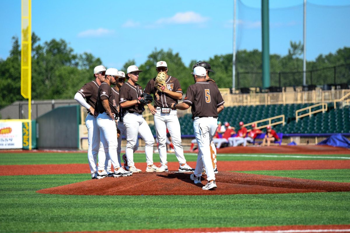 Avon, OH - Falcons head coach Kyle Hallock (5) walking to the mound to take out junior pitcher Nic Hood (25) at Crushers Stadium in Avon, Ohio.