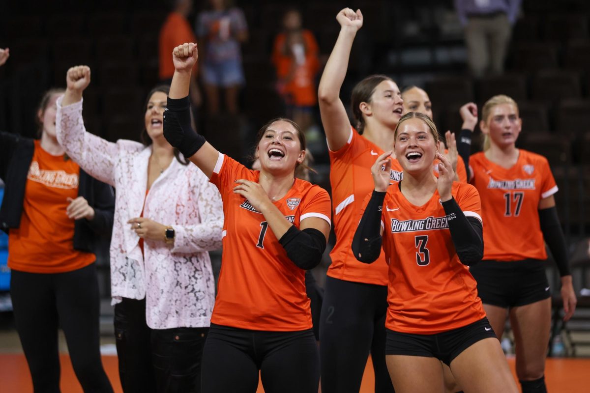 Bowling Green, OH - Falcons freshmen defensive specialists Sydnie Hernandez (1) and Avery Anders (3) look towards the crowd in celebration following their first BGSU Volleyball win against Chicago State
University at Stroh Center in Bowling Green Ohio