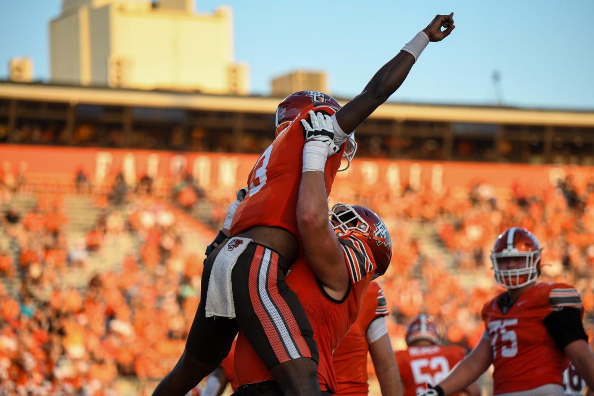 Bowling Green, OH - Falcons redshirt freshman quarterback Lucian Anderson III (3) celebrating his rushing touchdown with his linemen at Doyt Perry Stadium in Bowling Green, Ohio.