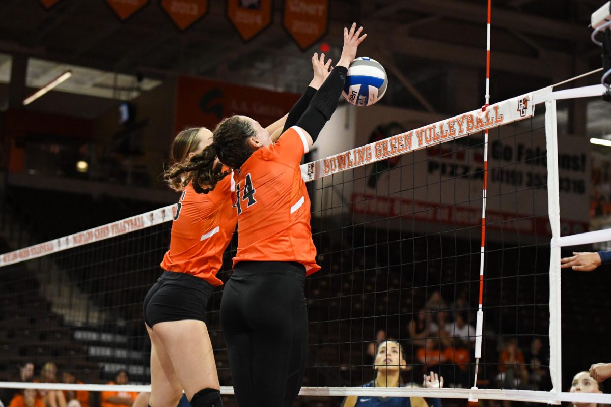 Bowling Green, OH - Falcons junior opposite Lauryn Hovey (14) and senior middle blocker Alexis Mattille (16) setting up a block to stop the Cougars at Stroh Center in Bowling Green Ohio